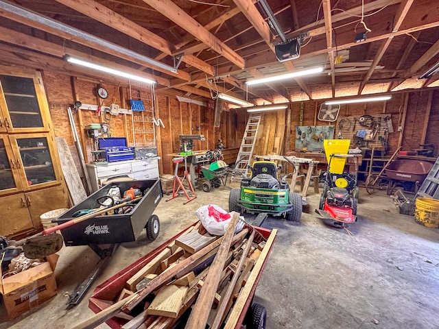 garage with a workshop area and a garage door opener