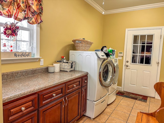 laundry room featuring light tile patterned flooring, washer and dryer, cabinet space, and ornamental molding