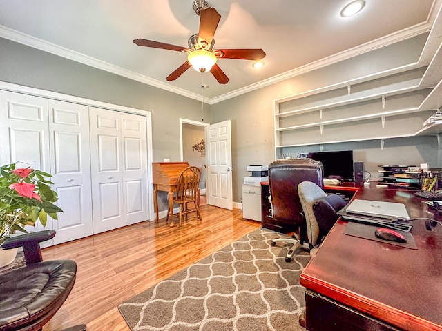 office area with baseboards, a ceiling fan, wood finished floors, and crown molding