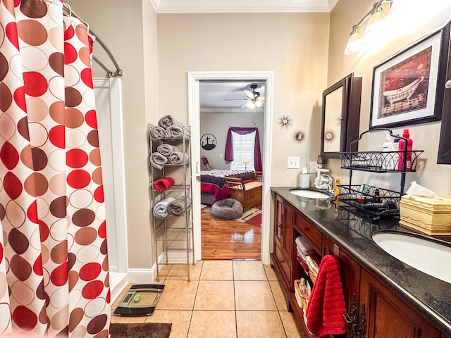 full bathroom featuring tile patterned floors, a sink, a shower with shower curtain, crown molding, and double vanity