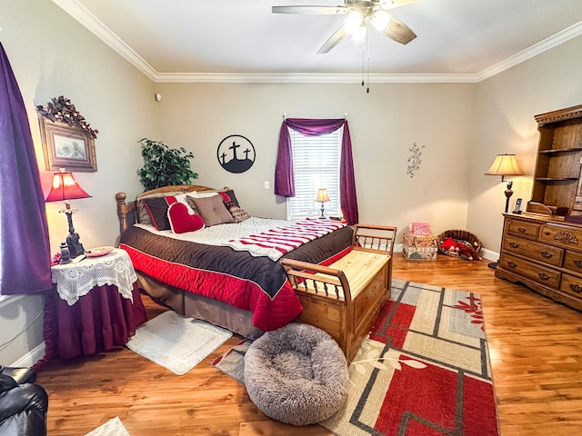 bedroom featuring ceiling fan, baseboards, wood finished floors, and ornamental molding