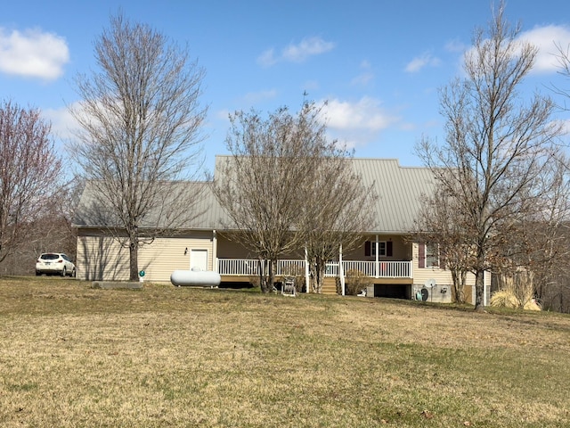 back of property with a lawn and metal roof