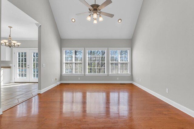 225 Blue Jay Pkwy, Ringgold, GA 30736 - unfurnished living room with high vaulted ceiling, ceiling fan with notable chandelier, wood finished floors, recessed lighting, and baseboards
