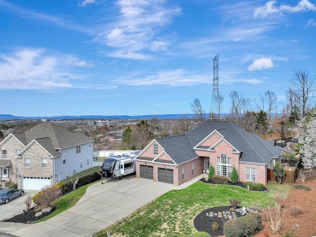 traditional home with fence, concrete driveway, a front yard, a garage, and brick siding