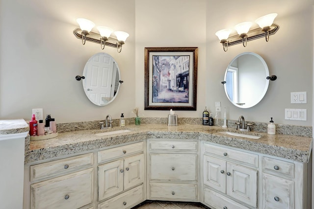 bathroom with a sink and double vanity