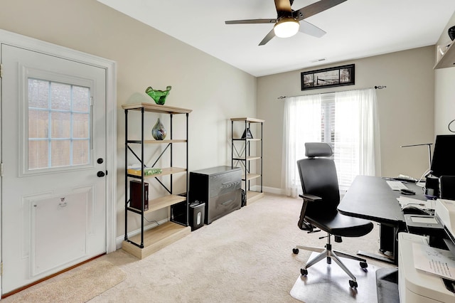 office space with baseboards, carpet, visible vents, and ceiling fan