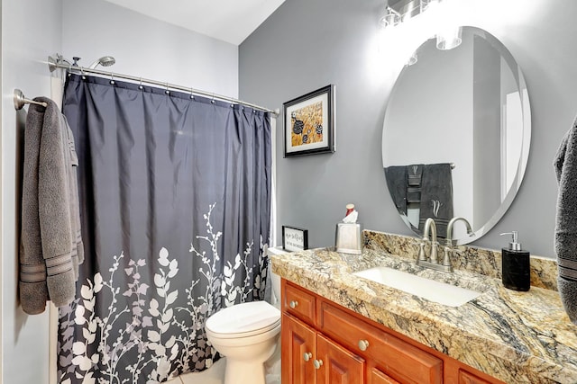 bathroom featuring a shower with shower curtain, toilet, and vanity