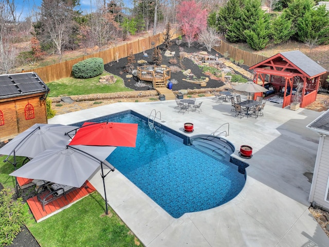 view of swimming pool with a fenced in pool, a gazebo, outdoor dining area, a fenced backyard, and a patio