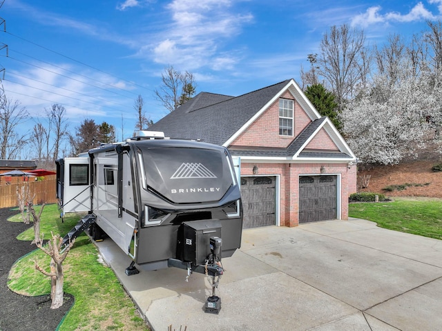 view of front of home featuring fence, concrete driveway, a front yard, a shingled roof, and a garage