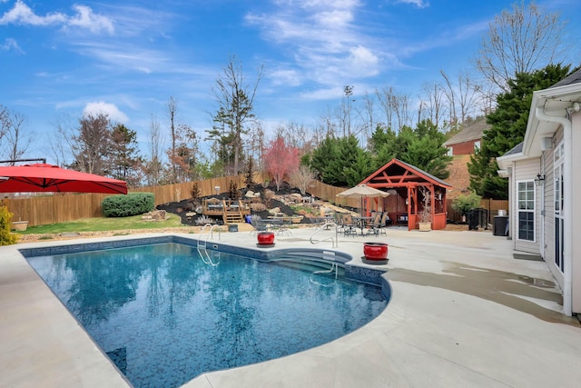 view of pool with a gazebo, a fenced backyard, a fenced in pool, and a patio