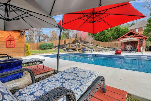 view of swimming pool with outdoor dining space, a patio area, a fenced backyard, and a fenced in pool