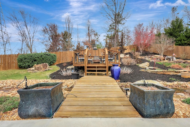 exterior space featuring a wooden deck and a fenced backyard