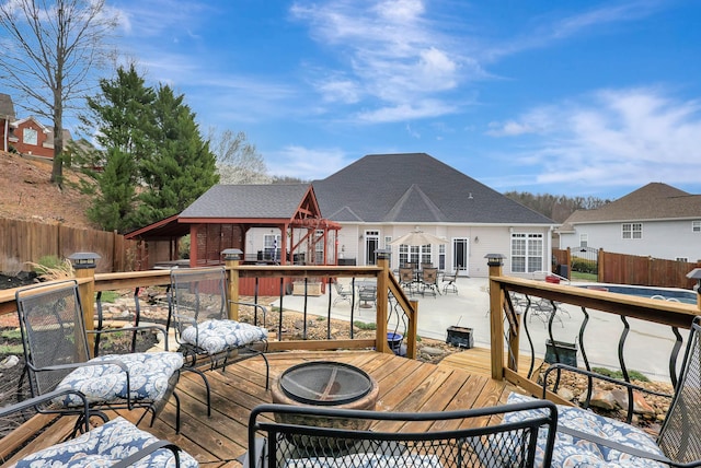 wooden terrace featuring outdoor dining area, fence, and grilling area