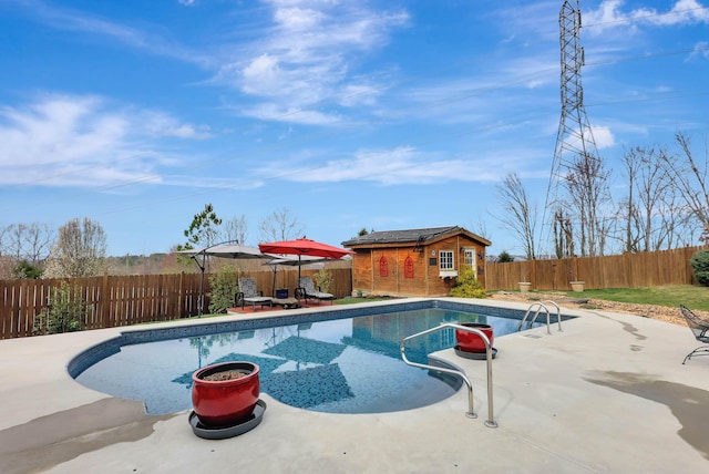 view of swimming pool with an outdoor structure, a fenced backyard, a fenced in pool, and a patio