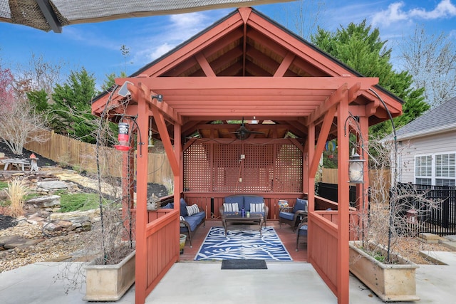 view of patio / terrace with a gazebo, ceiling fan, outdoor lounge area, and fence