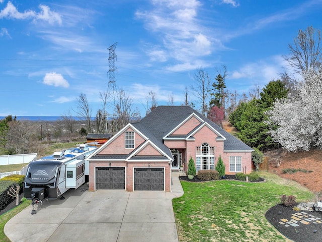 traditional-style house featuring brick siding, concrete driveway, a front lawn, and fence