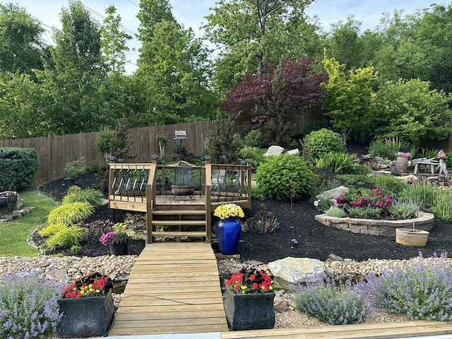 view of yard with fence and a wooden deck