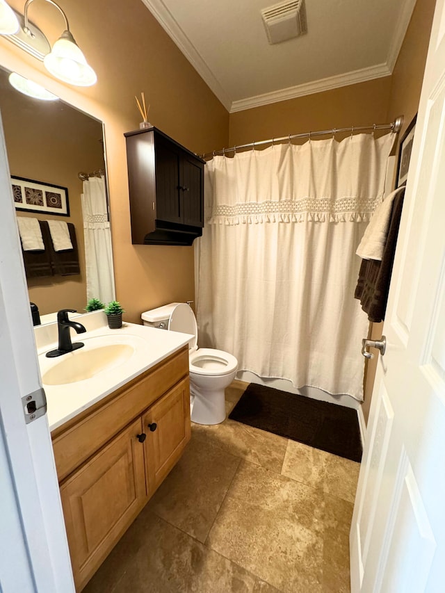 bathroom with visible vents, toilet, vanity, and ornamental molding