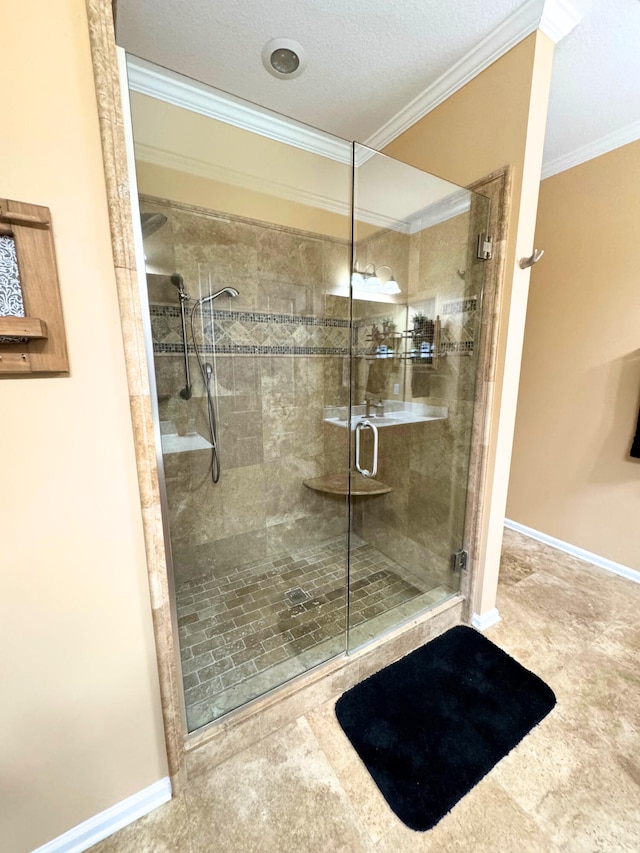 full bath featuring baseboards, a textured ceiling, a shower stall, and crown molding