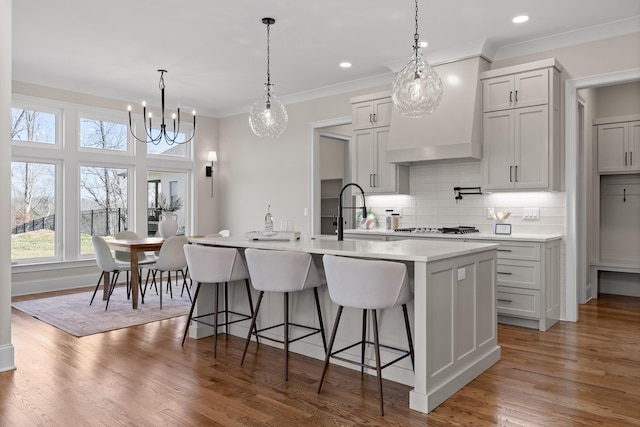 1825 River Breeze Dr, Soddy Daisy, TN 37379 - kitchen featuring light countertops, ornamental molding, a kitchen island with sink, and a sink