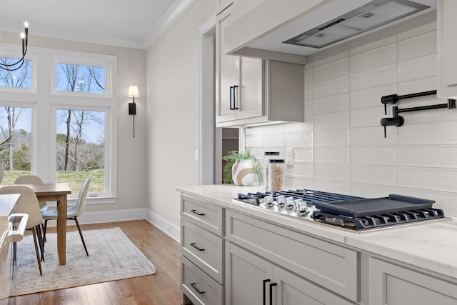 1825 River Breeze Dr, Soddy Daisy, TN 37379 - kitchen with tasteful backsplash, crown molding, baseboards, wall chimney range hood, and light wood-style floors