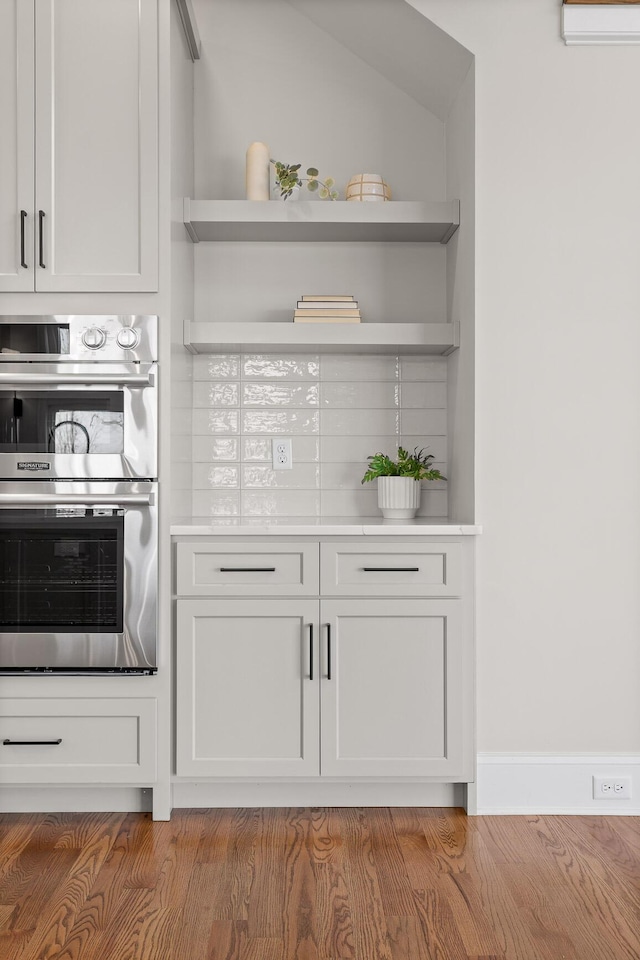 1825 River Breeze Dr, Soddy Daisy, TN 37379 - kitchen featuring open shelves, an AC wall unit, light countertops, and stainless steel double oven