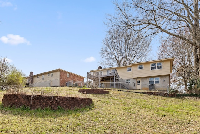 rear view of property featuring stairs, a yard, fence, and a wooden deck