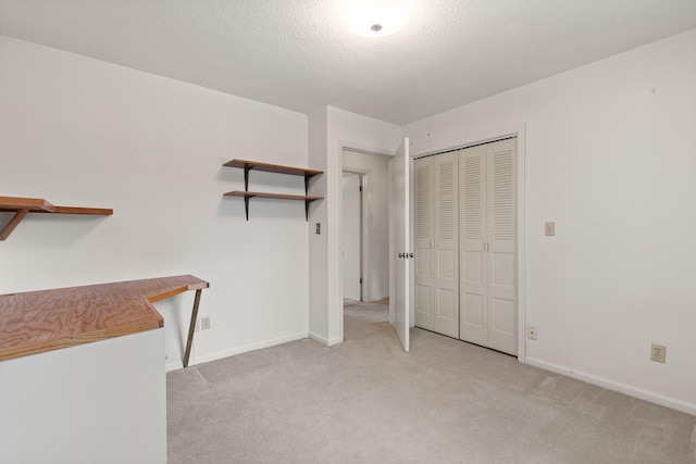 spacious closet featuring light colored carpet