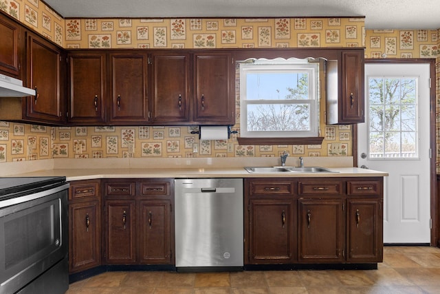 kitchen featuring wallpapered walls, a sink, under cabinet range hood, range with electric stovetop, and dishwasher