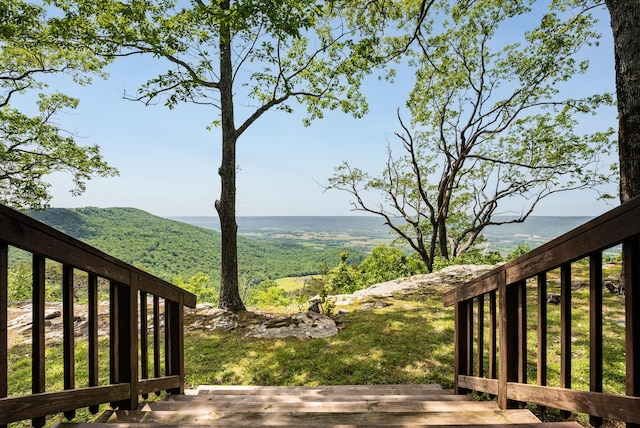 view of yard with a deck with mountain view