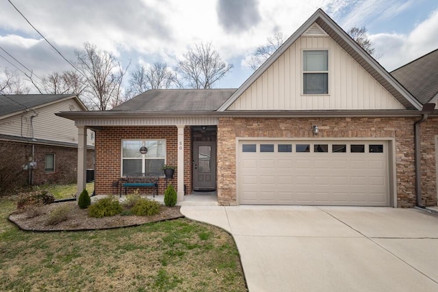 view of front of property featuring brick siding, an attached garage, board and batten siding, a porch, and driveway