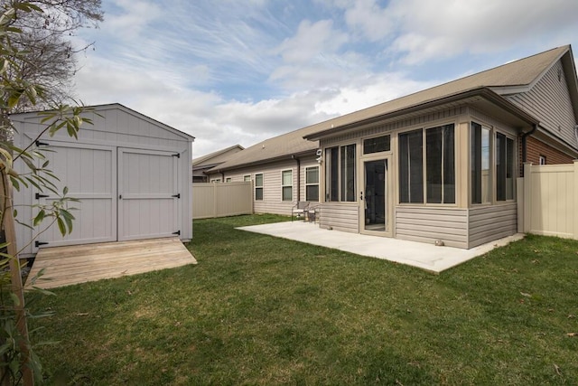 rear view of house with an outbuilding, a shed, a yard, and a fenced backyard