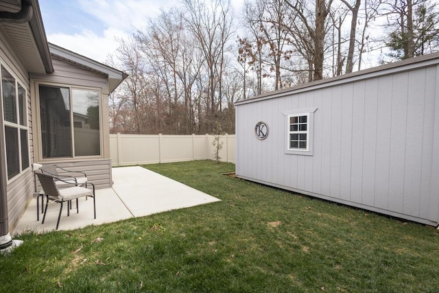 view of yard featuring a patio, an outbuilding, and a fenced backyard