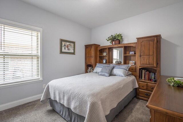 carpeted bedroom featuring baseboards