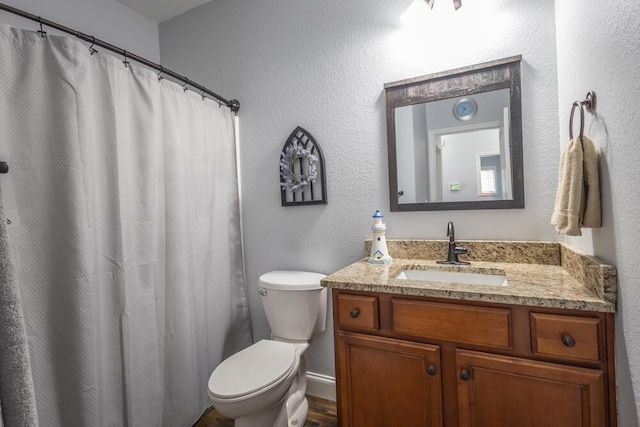 full bathroom with vanity, a shower with shower curtain, and toilet