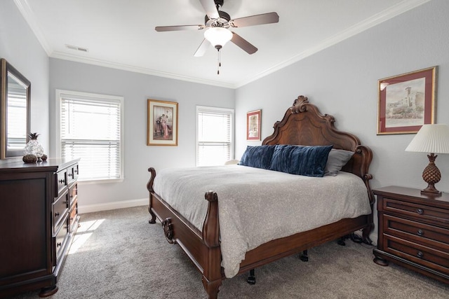 carpeted bedroom featuring ceiling fan, visible vents, baseboards, and ornamental molding