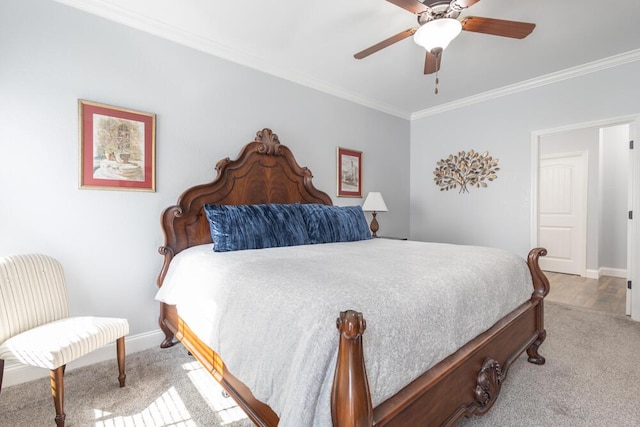 carpeted bedroom featuring crown molding, baseboards, and ceiling fan