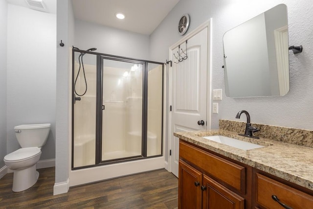 full bath featuring visible vents, toilet, a stall shower, wood finished floors, and vanity