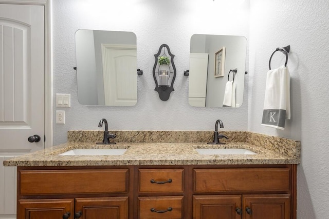 full bathroom featuring double vanity and a sink