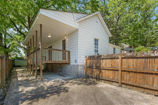 view of property exterior featuring a deck, fence private yard, and a patio area