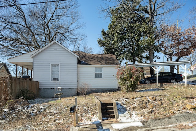 exterior space featuring a carport and roof with shingles