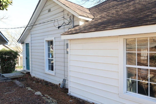 view of property exterior featuring roof with shingles