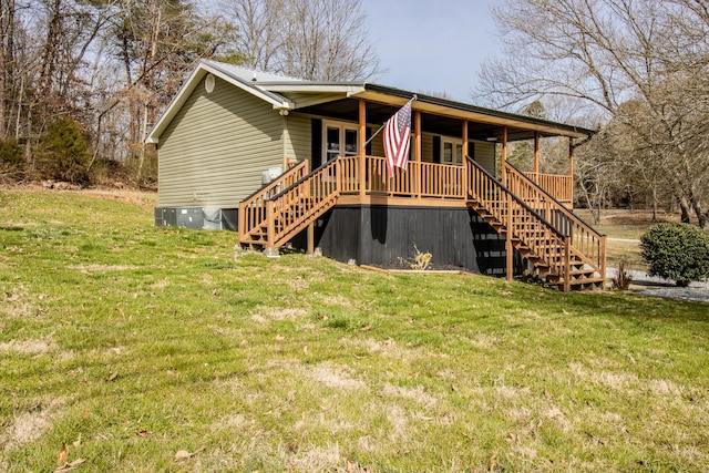 rear view of property featuring stairs, a yard, and central AC unit