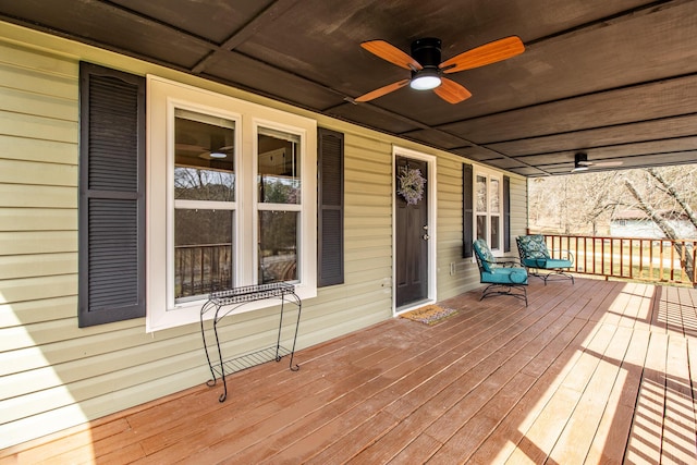 wooden deck with a porch and ceiling fan