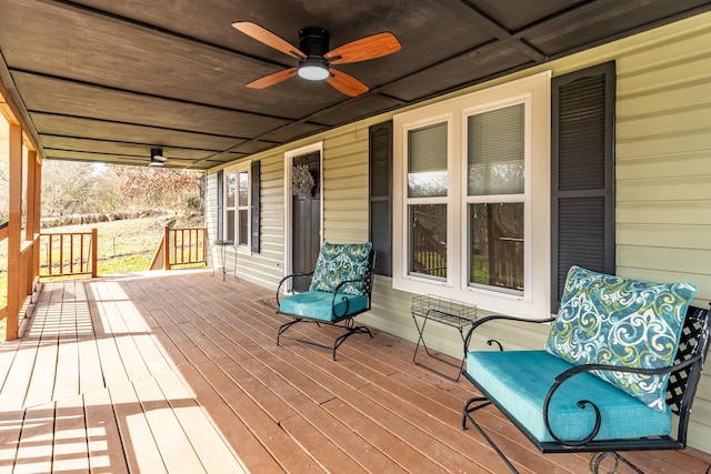 wooden terrace featuring a porch and ceiling fan