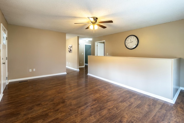 unfurnished room with visible vents, a ceiling fan, a textured ceiling, wood finished floors, and baseboards