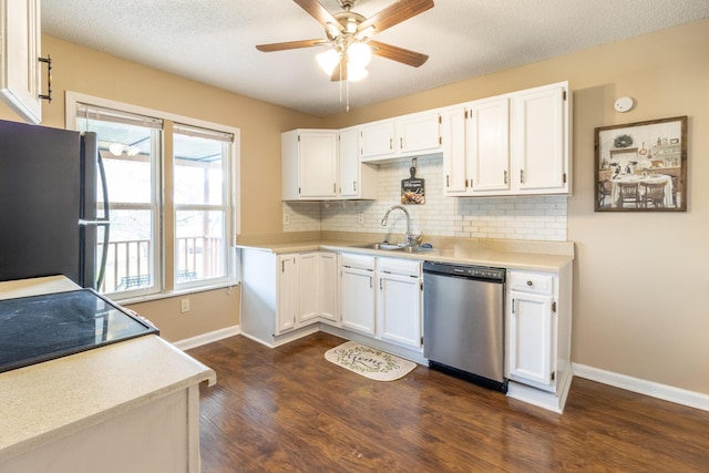 kitchen with white cabinets, dishwasher, freestanding refrigerator, and a sink