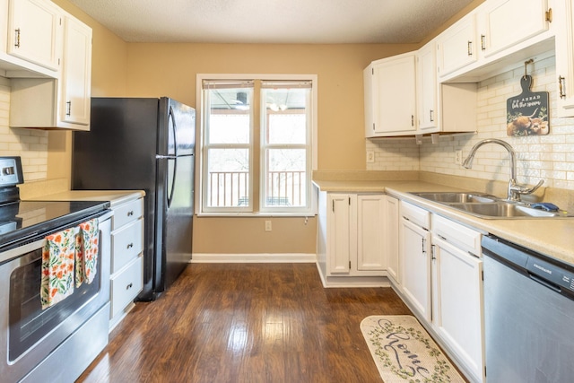 kitchen featuring a sink, dark wood-style floors, white cabinetry, appliances with stainless steel finishes, and light countertops