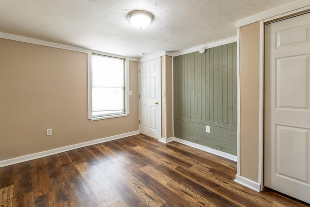 unfurnished bedroom with dark wood-style floors and baseboards