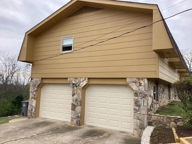 2813 Nile Rd, Chattanooga, TN 37421 - view of property exterior with concrete driveway, stone siding, and an attached garage